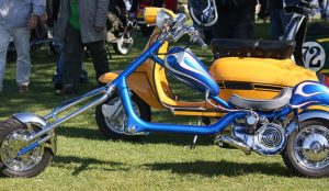 A blue chopper with flames on the petrol tank