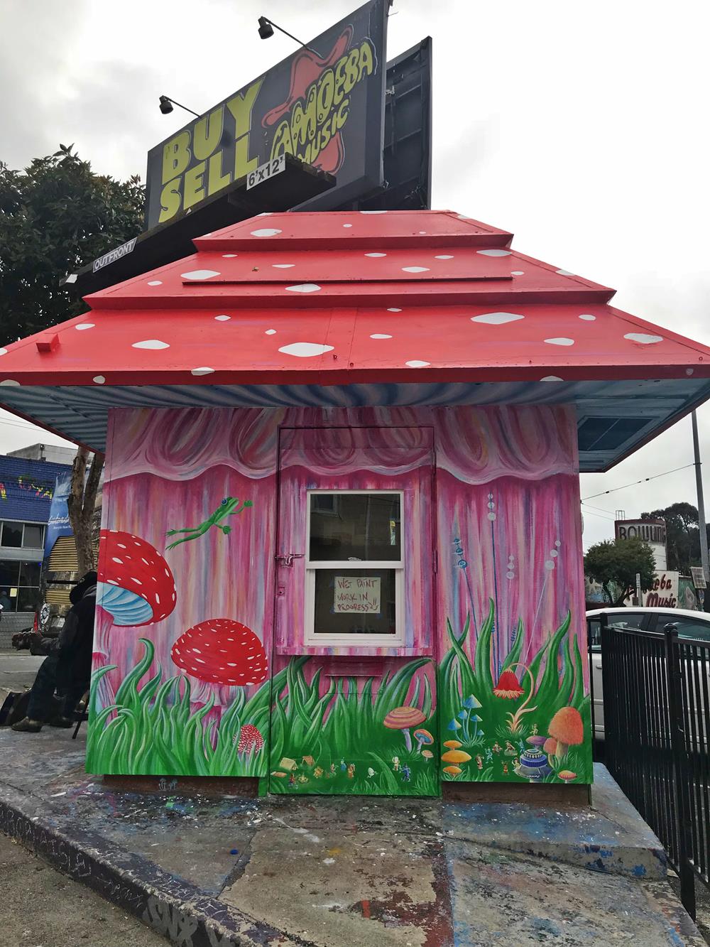 Pink and red kiosk on Haight and Shrader featuring painted wildlife and titled Mushroom With A View