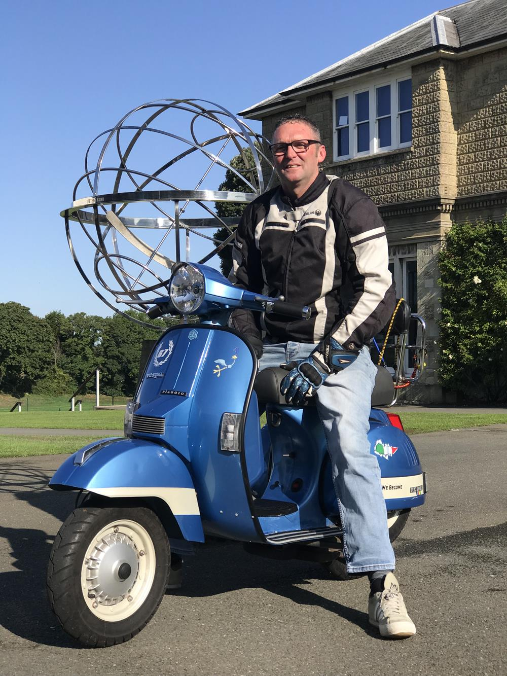 Scooter rider on blue PX Vespa scooter