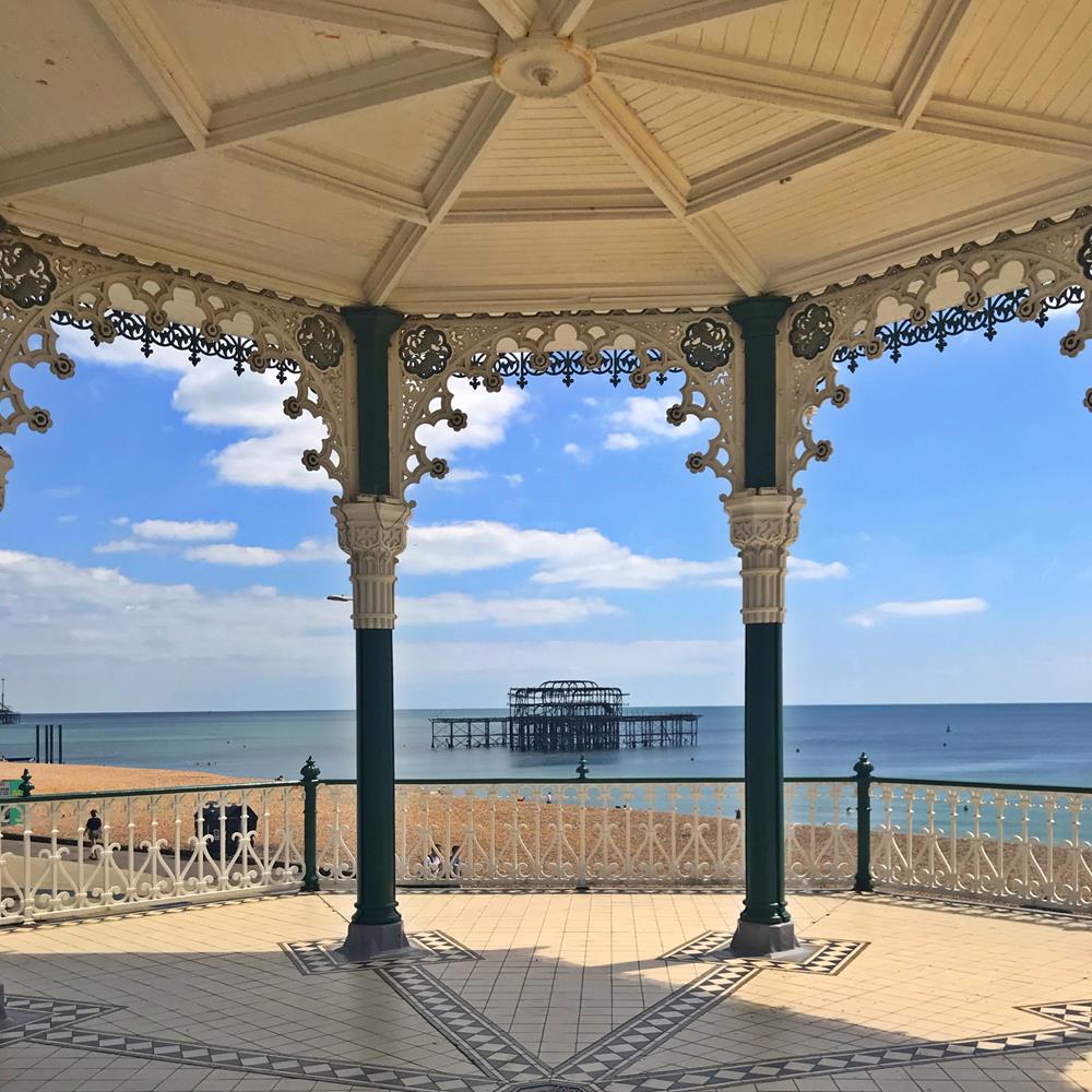 View of Brighton's West Pier from a promenade bandstand