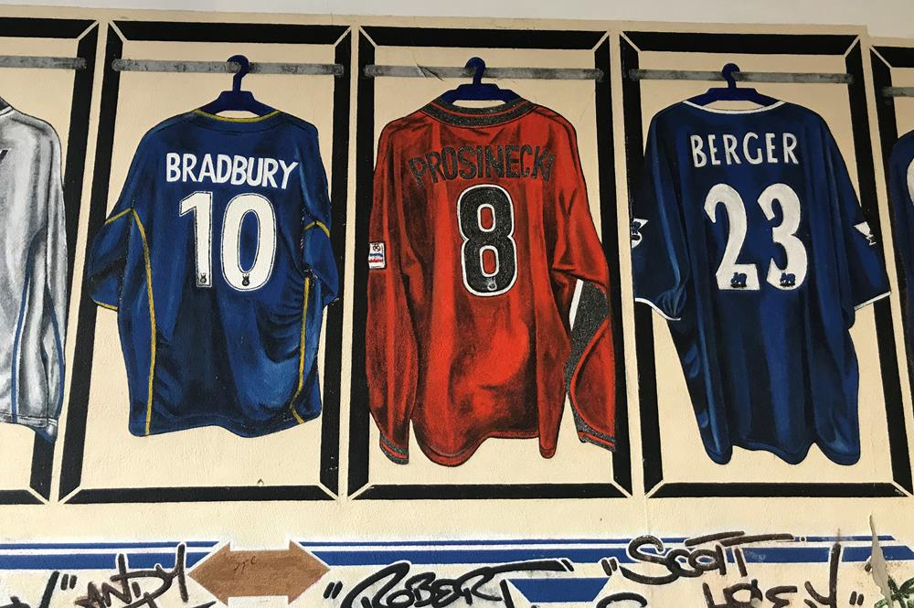 A mural featuring Portsmouth football shirts including Lee Bradbury, Robert Prosinecki and Patrick Berger, painted by Nigel Sharman AKA AceOne Designs.