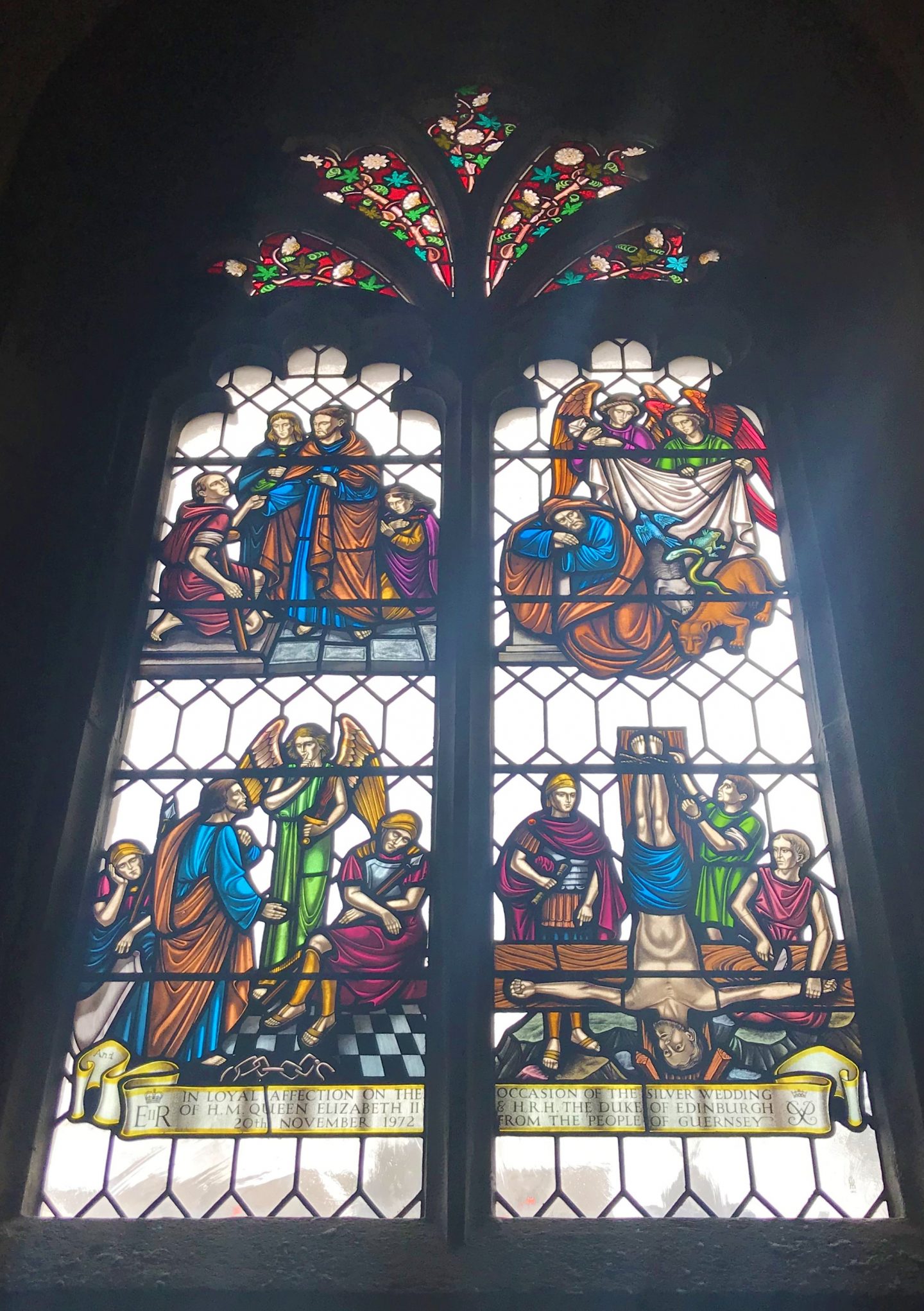 Stained glass window depicting the upside down crucifixion of St Peter in the town church of St Peter Port