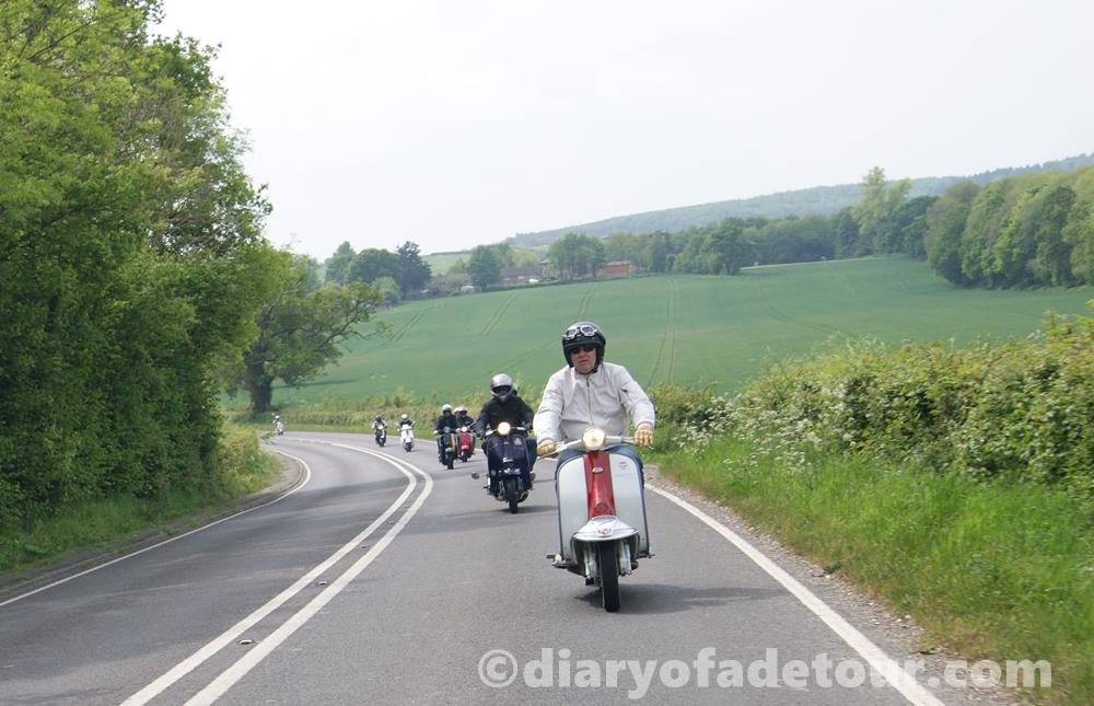Lambretta scooters riding along a country lane in West Sussex