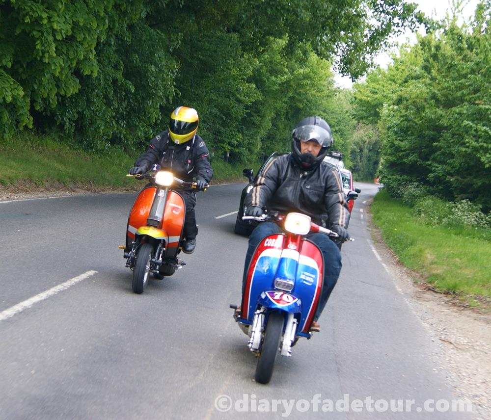Street style scooters riding along a country lane