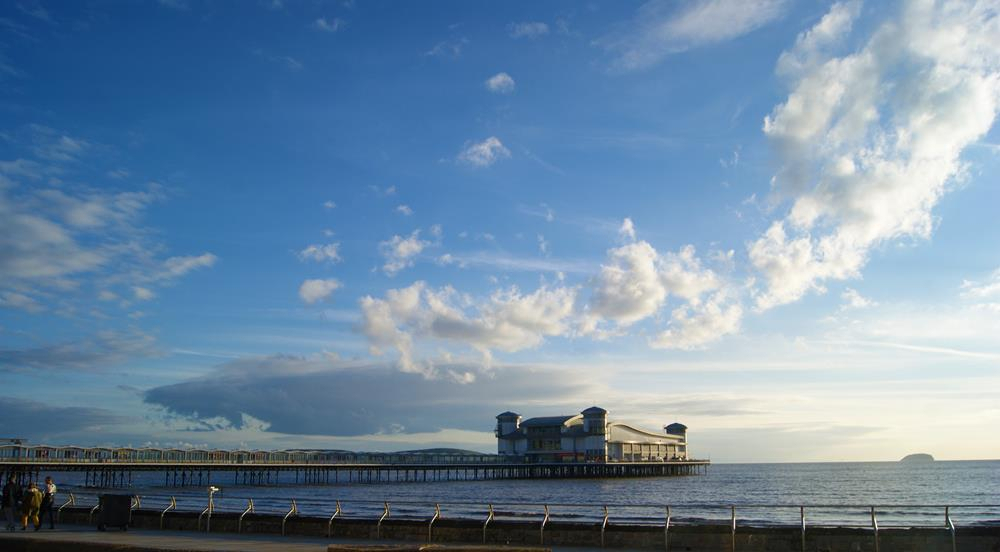 Weston Super Mare Grand Pier with blue sky and clouds in the background.