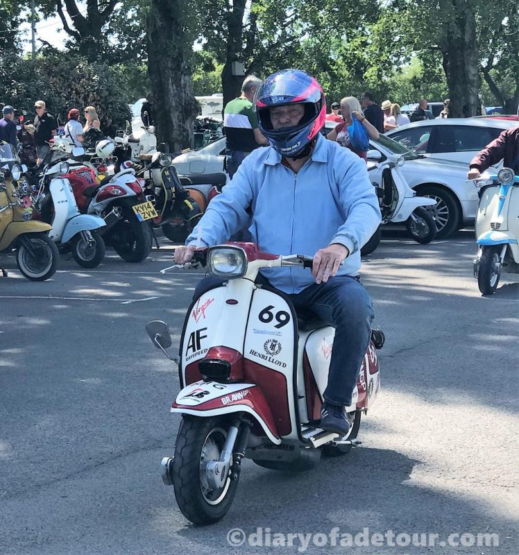 Scooter rider on a white and red Arthur Francis Lambretta