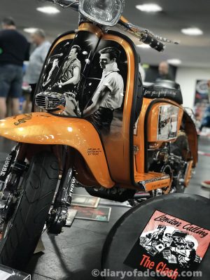 Breaking-Rocks-In-The-Hot-Sun-Lambretta Orange custom Lambretta with a Clash theme, called Breaking Rocks In The Hot Sun, shown at Scooter Expo in Alfreton with London Calling spare wheel cover