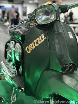 Dazzle-Lambretta-Drizzle-legshield-cover Green legshield cover with Drizzle lettering on the front of Dazzle at Scooter Expo in 2019
