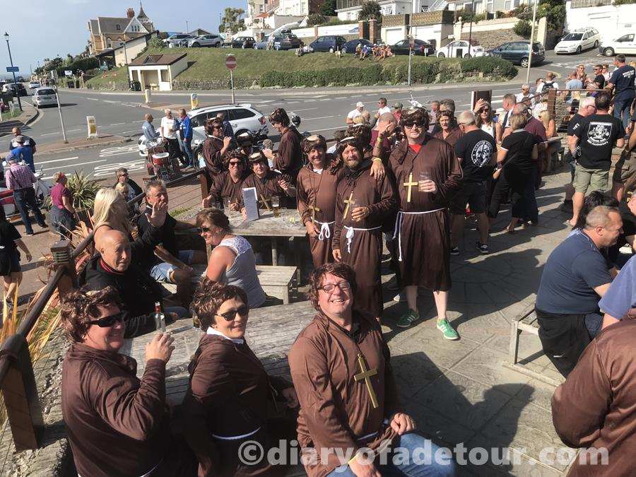 Scooterists in fancy dress outside the Red Barn in Woolacombe, dressed as monks.