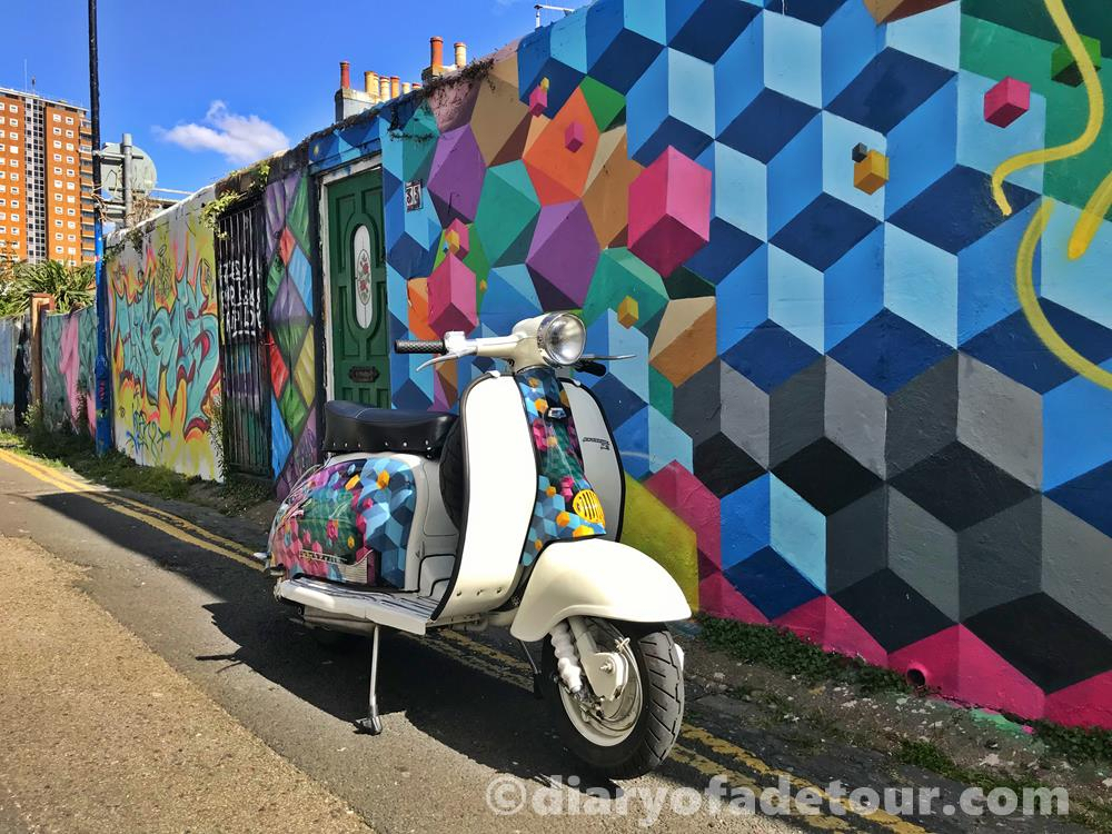 Lambretta Series 2 scooter with street art mural by Snub23 in Trafalgar Lane, Brighton