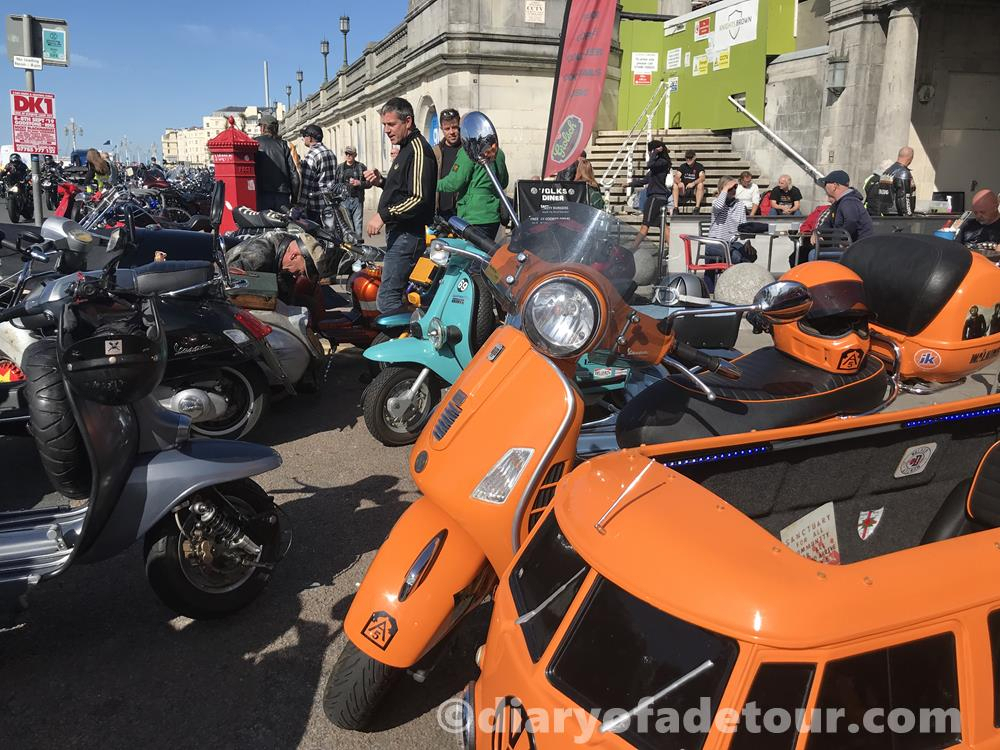 Orange GTS with VW sidecar parked with other scooters outside Volk's bar in Brighton