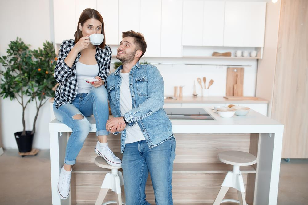Young couple sitting in their kitchen
