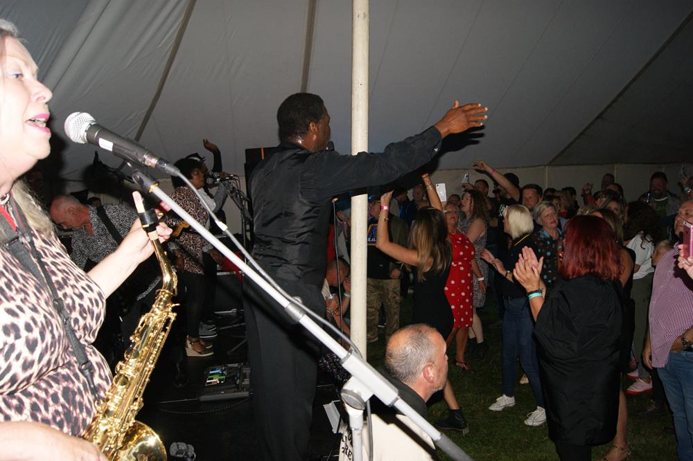 Angelo Starr and the rally crowd enjoying his performance at Sandown Airport at the VFM Isle of Wight scooter rally