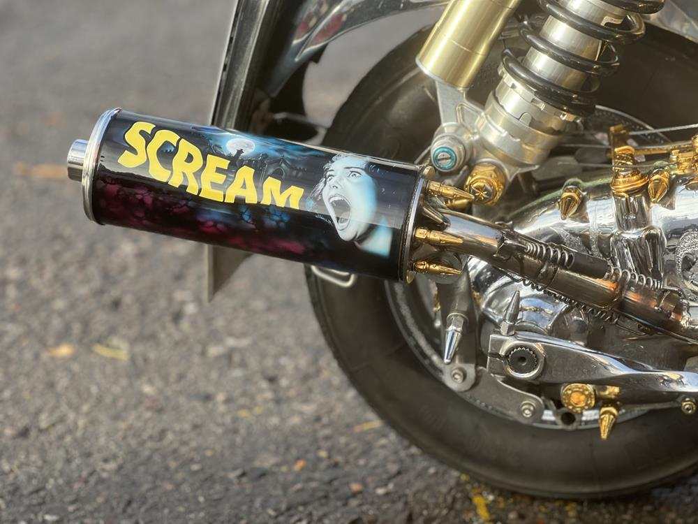 Exhaust pipe for a Lambretta scooter with Scream horror film image on with a woman screaming