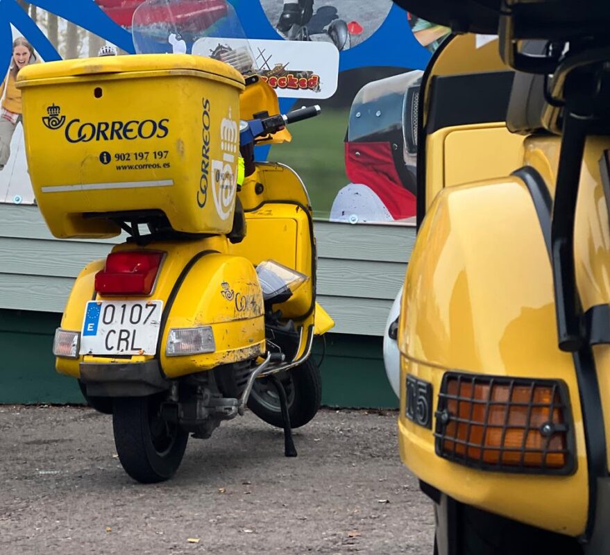 A yellow Spanish post office scooter