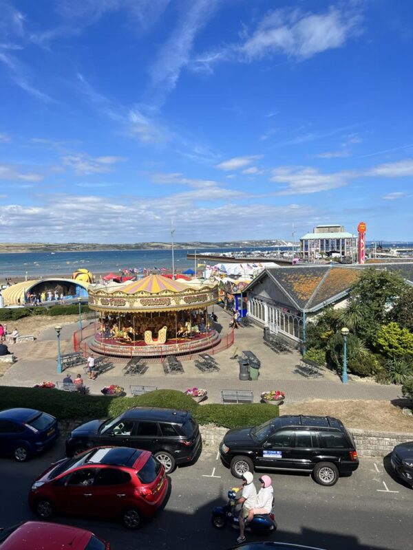 View over the funfair at Weymouth to the Pavilion and sea