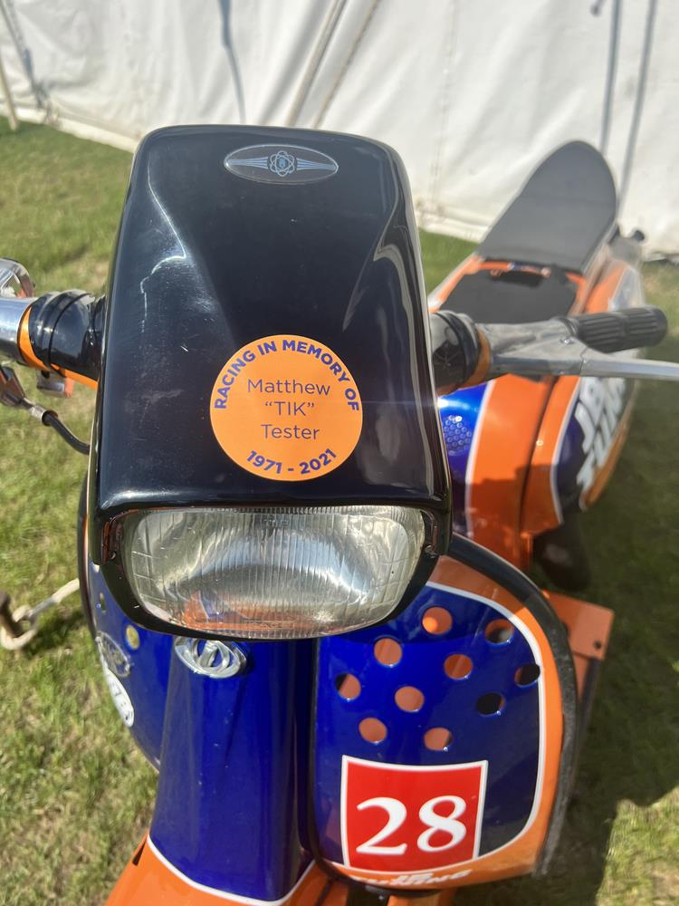 Tik Tester's Lambretta street racer - an orange and navy blue scooter with number 28 on the front.