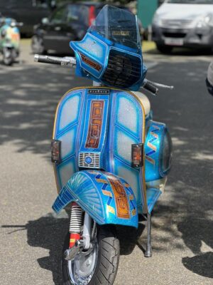 A blue and silver metalflake P range Vespa with Driver screen