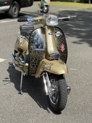 Brassy Bitch, a black and gold metalflake custom Lambretta
