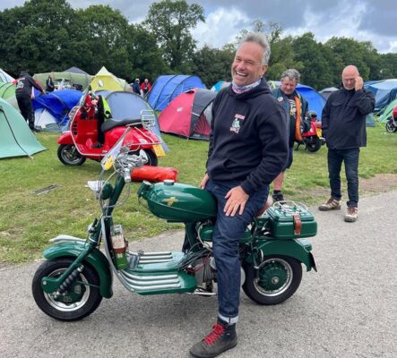 Andy Purdy with his green Lambretta Model D at Big 7 national scooter rally at the South of England Showground in Ardingly.