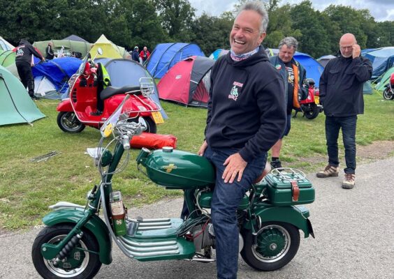 Andy Purdey from Reading Rabble SC sitting on his bottle green Lambretta Model D at Big 7 Scooter Rally