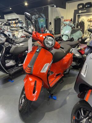 Orange Vespa GTS inside the showroom at Dearden Motorcycles