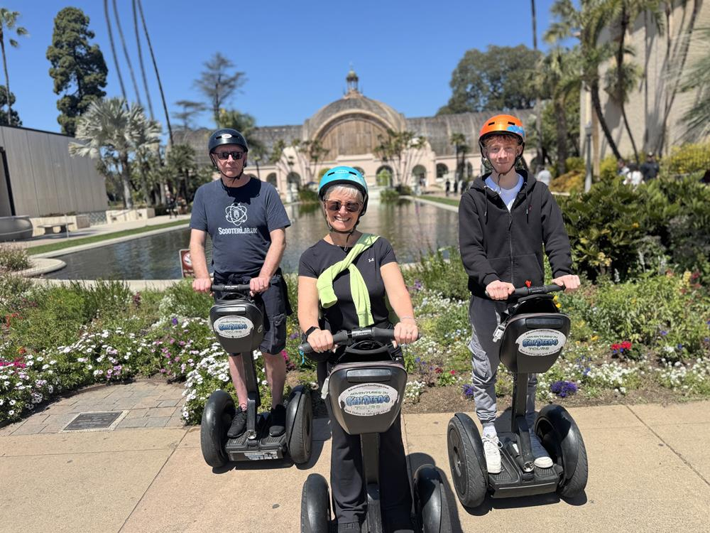 Three people on Segways in the gardens of Balboa Park in San Diego
