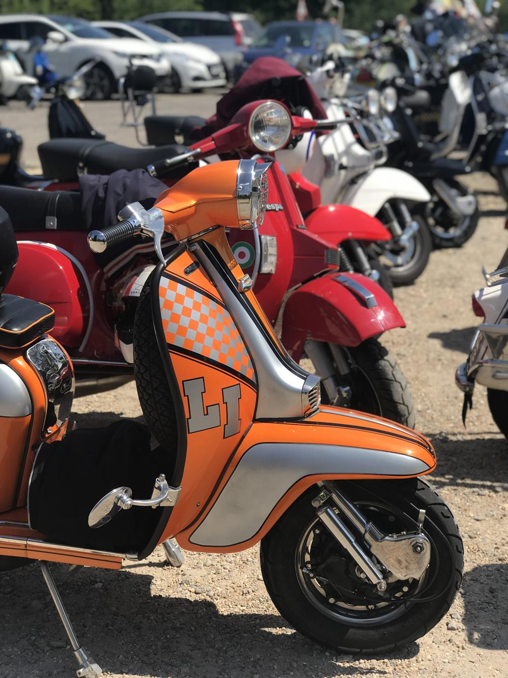 Orange Lambretta LI with other scooters in the background